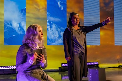 Rachel Rhea Shannon as Vashti and Lya Yanne as Flight Attendant