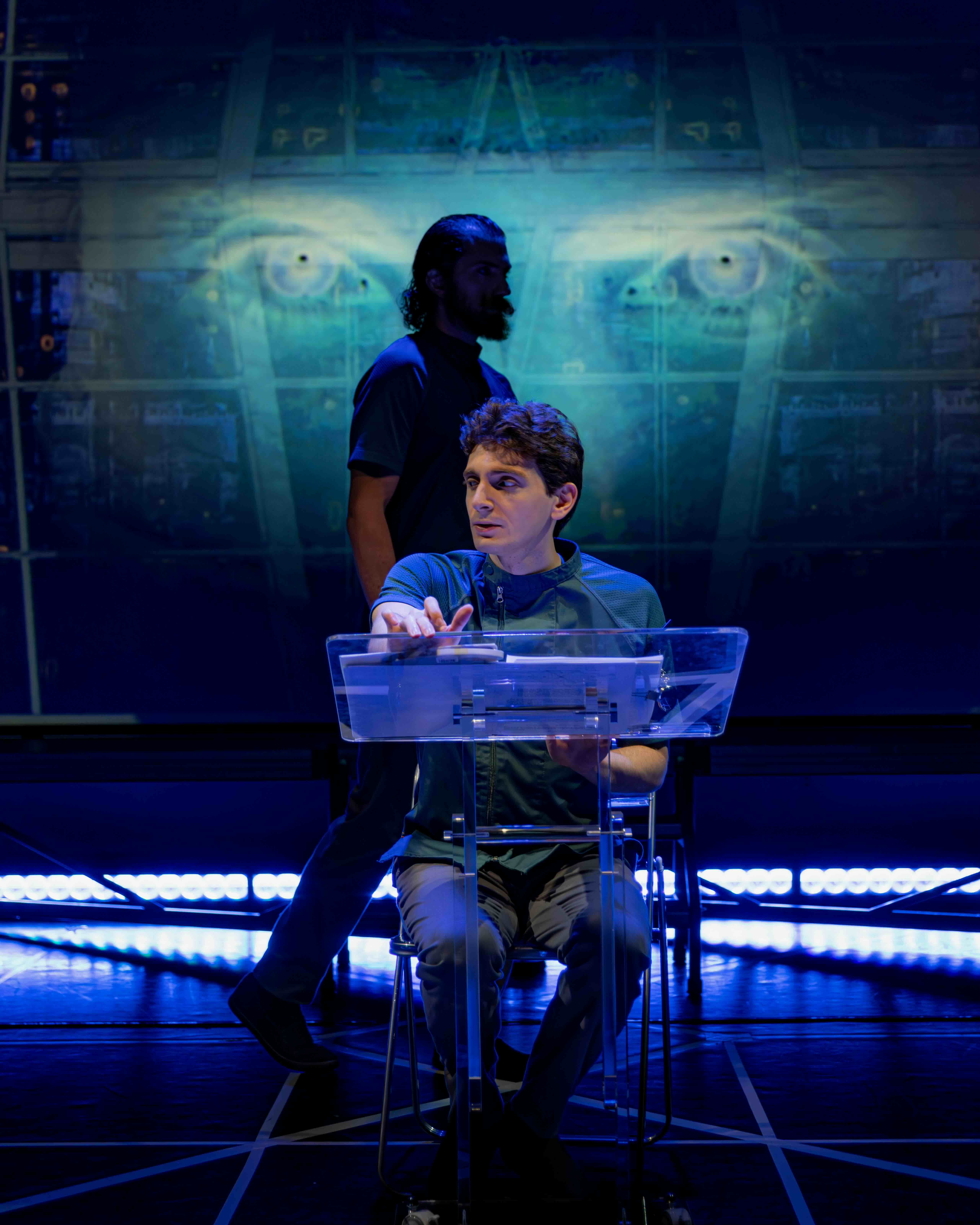  Ian Cramer as S-4711 and Aaron Greenberg as D-503. 